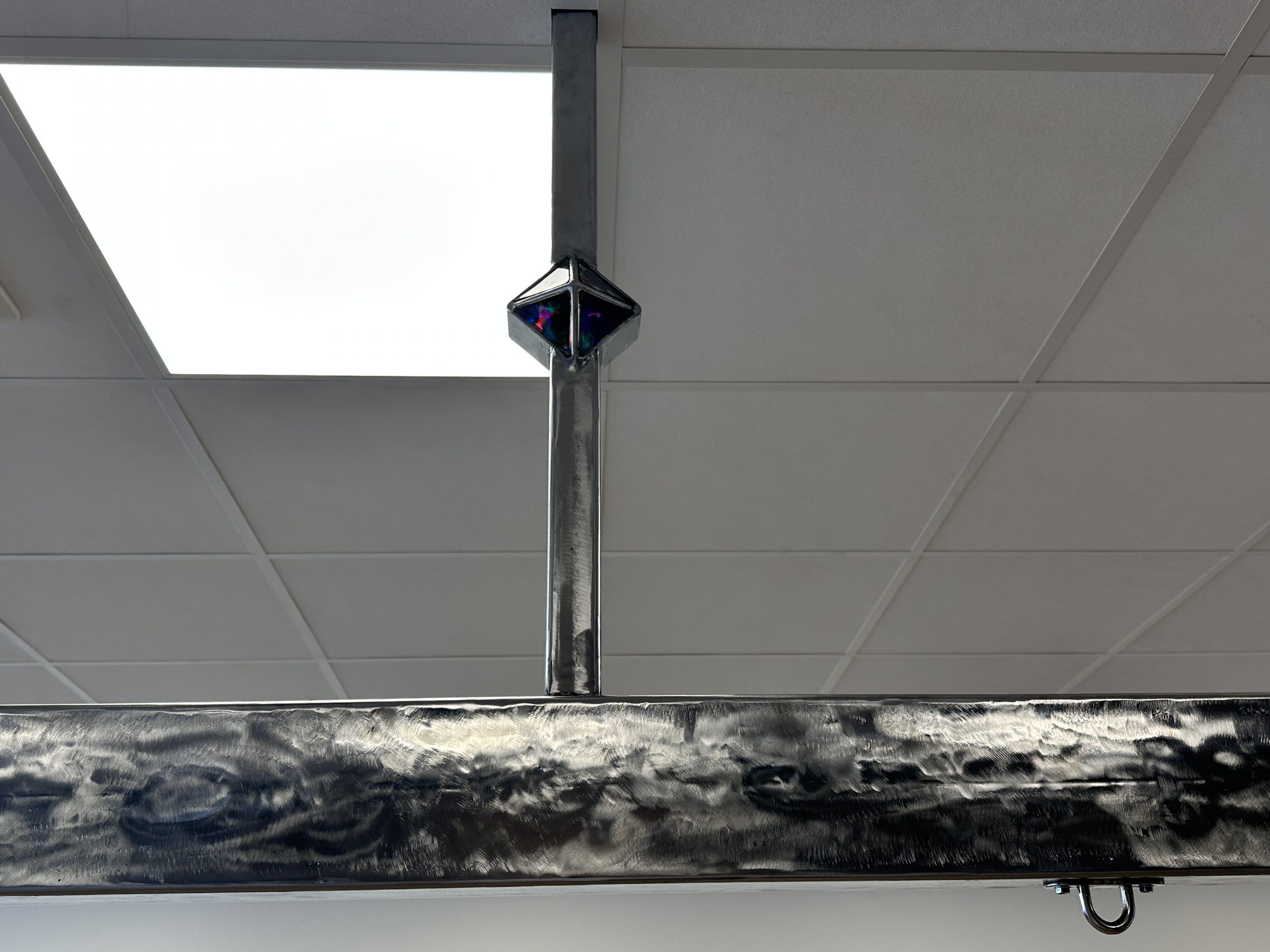 Barre de training en métal de 3.50m de long. Encoches métallique de support  avec renfort au plafond surmonté d'un losange en résine époxy.